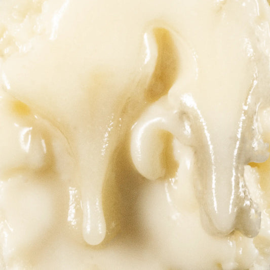 Close-up of THCA Badder showing whipped texture and glossy surface
